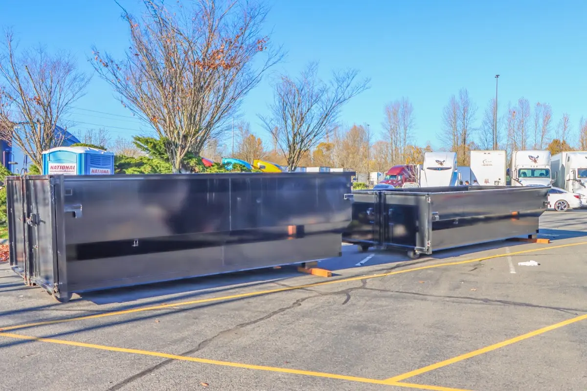 Professional dumpster rental service with roll-off container on residential driveway in Asheville